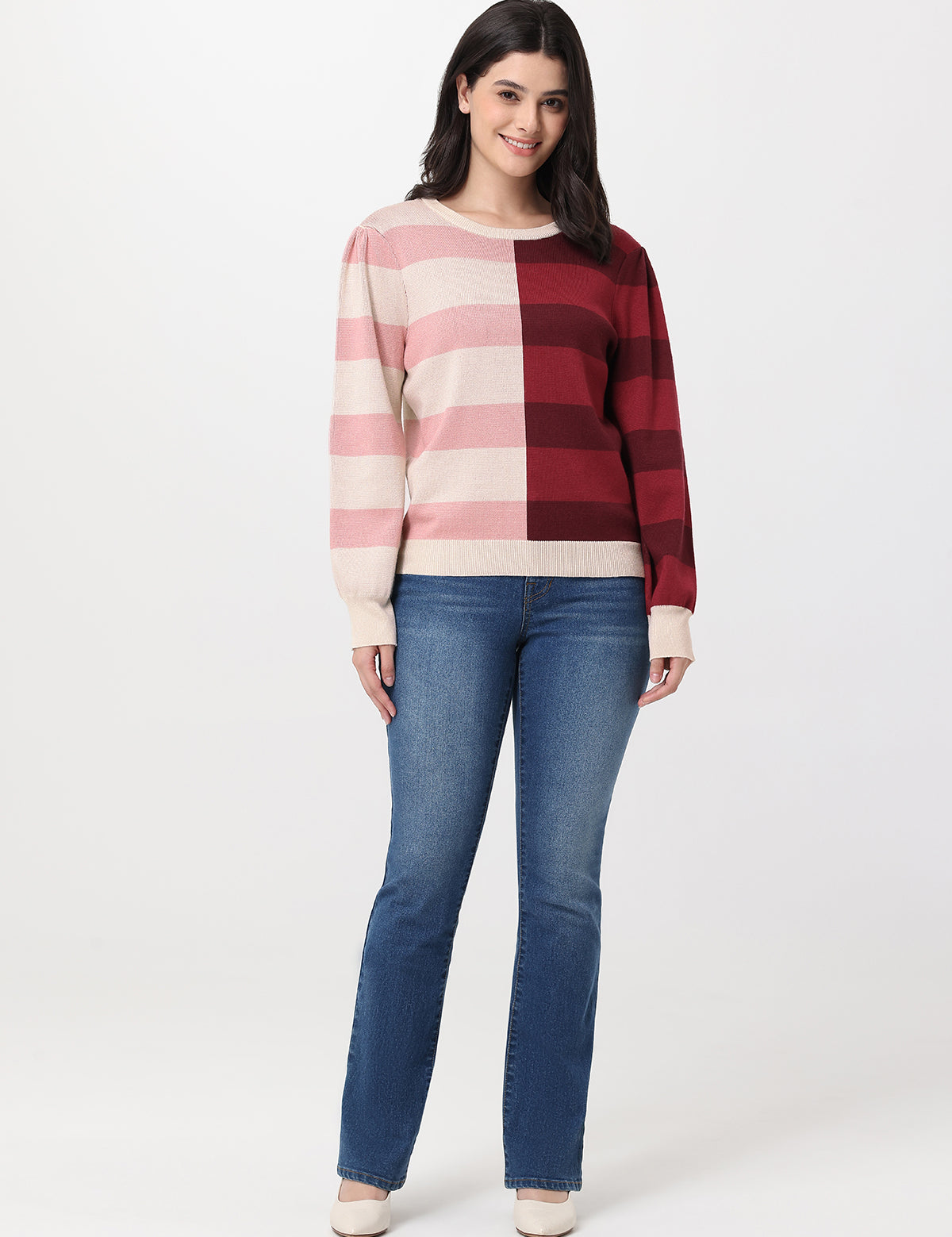 Woman wearing a checkered sweater and jeans on a white background