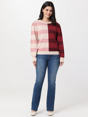 Woman wearing a checkered sweater and jeans on a white background