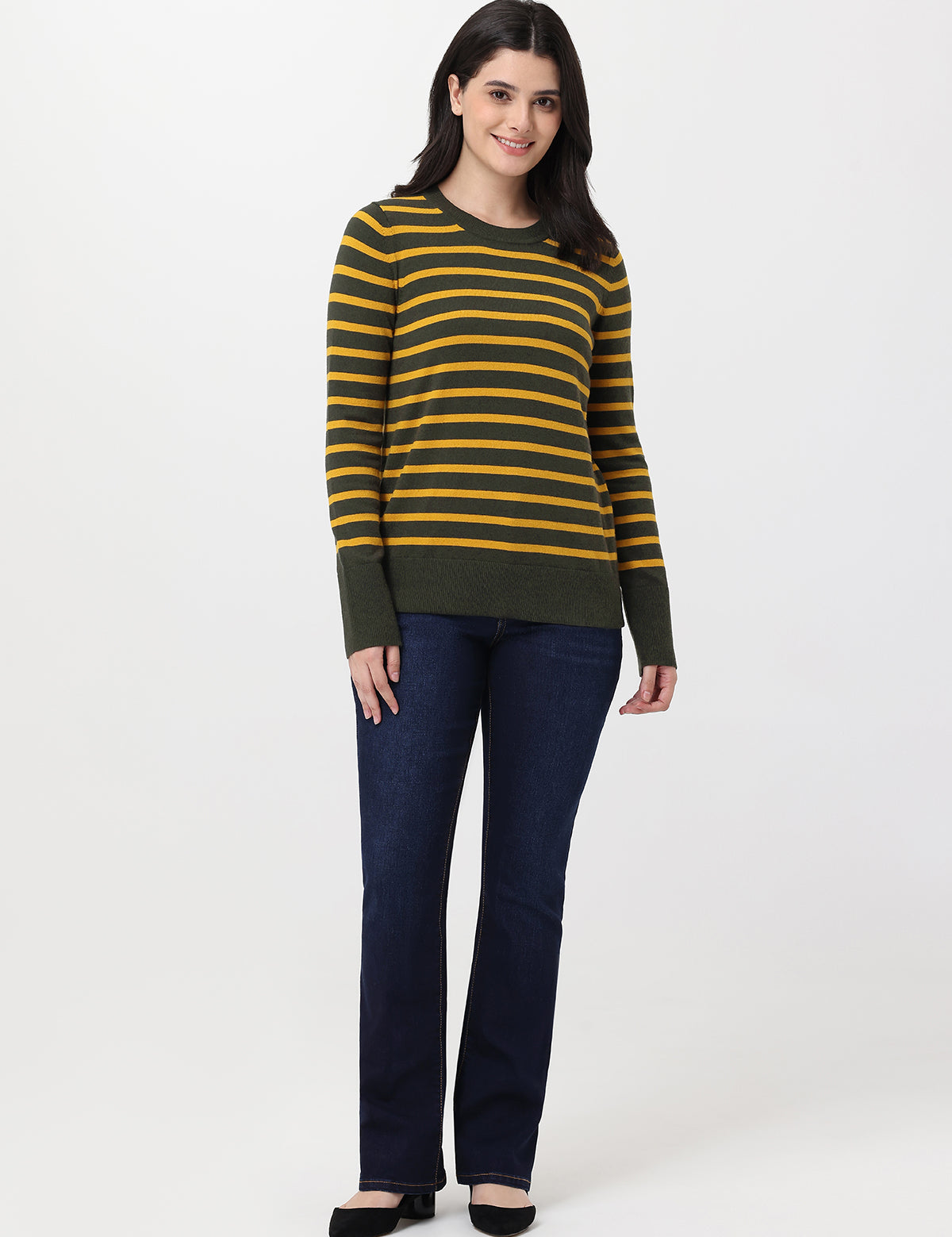 Woman wearing a striped sweater and jeans on a white background