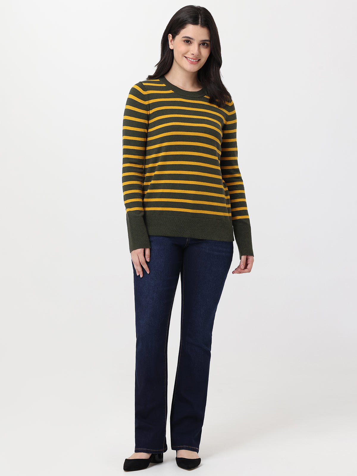 Woman wearing a striped sweater and jeans on a white background