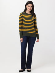 Woman wearing a striped sweater and jeans on a white background
