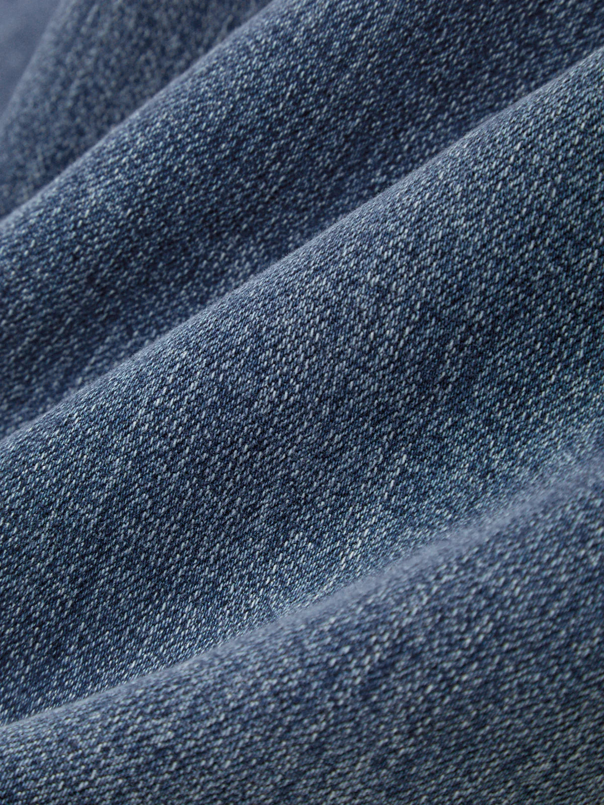 Close-up of blue denim fabric with a textured pattern