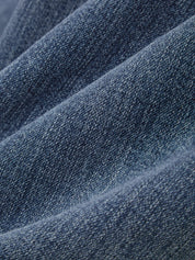 Close-up of blue denim fabric with a textured pattern