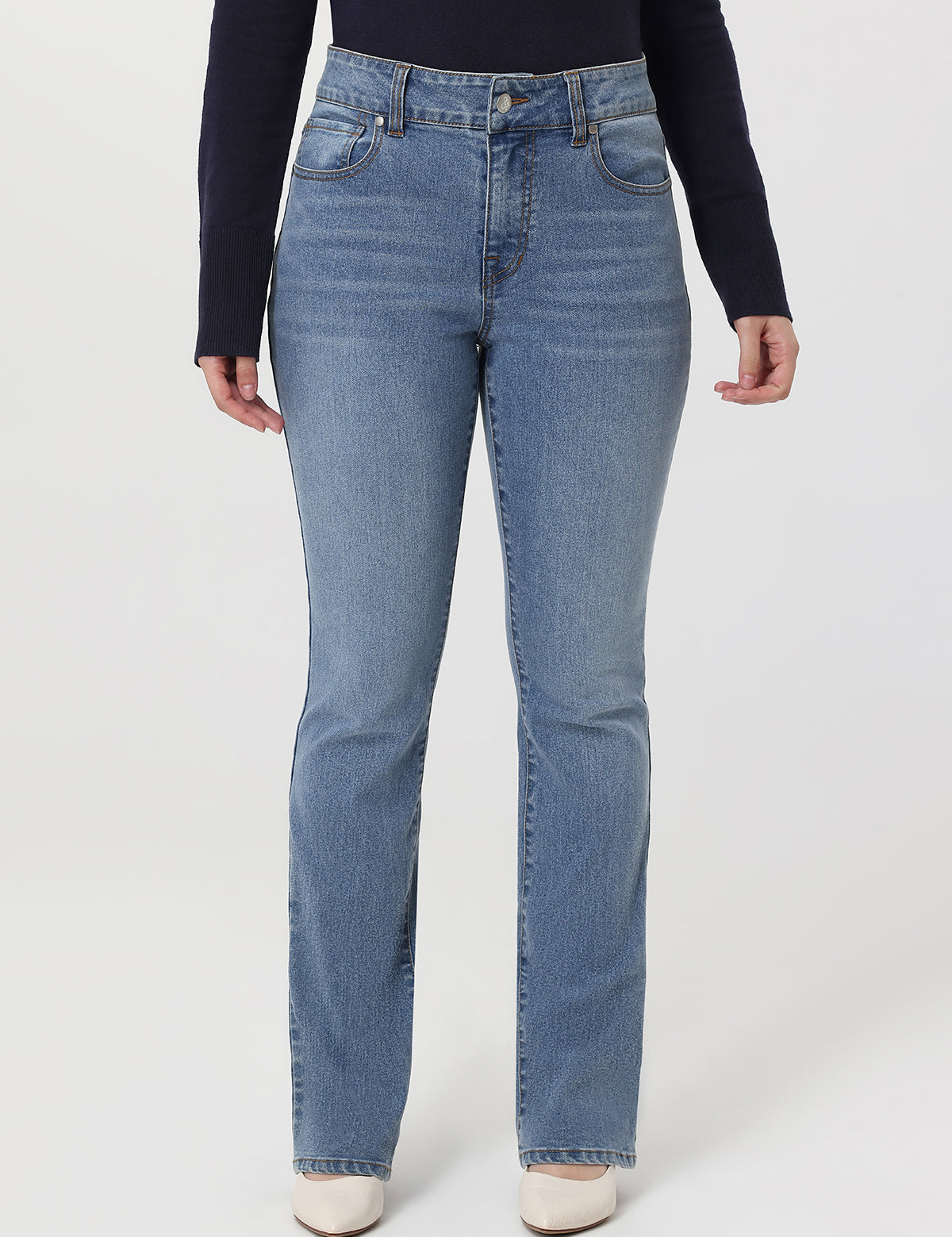 Person wearing light blue jeans on a white background