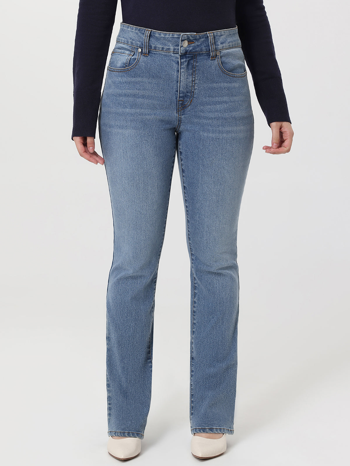 Person wearing light blue jeans on a white background