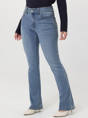 Light blue flared jeans worn by a person on a white background