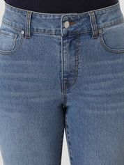 Close-up of blue jeans with a focus on the waistband and front pocket.