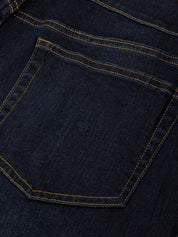 Close-up of a dark blue denim pocket with yellow stitching
