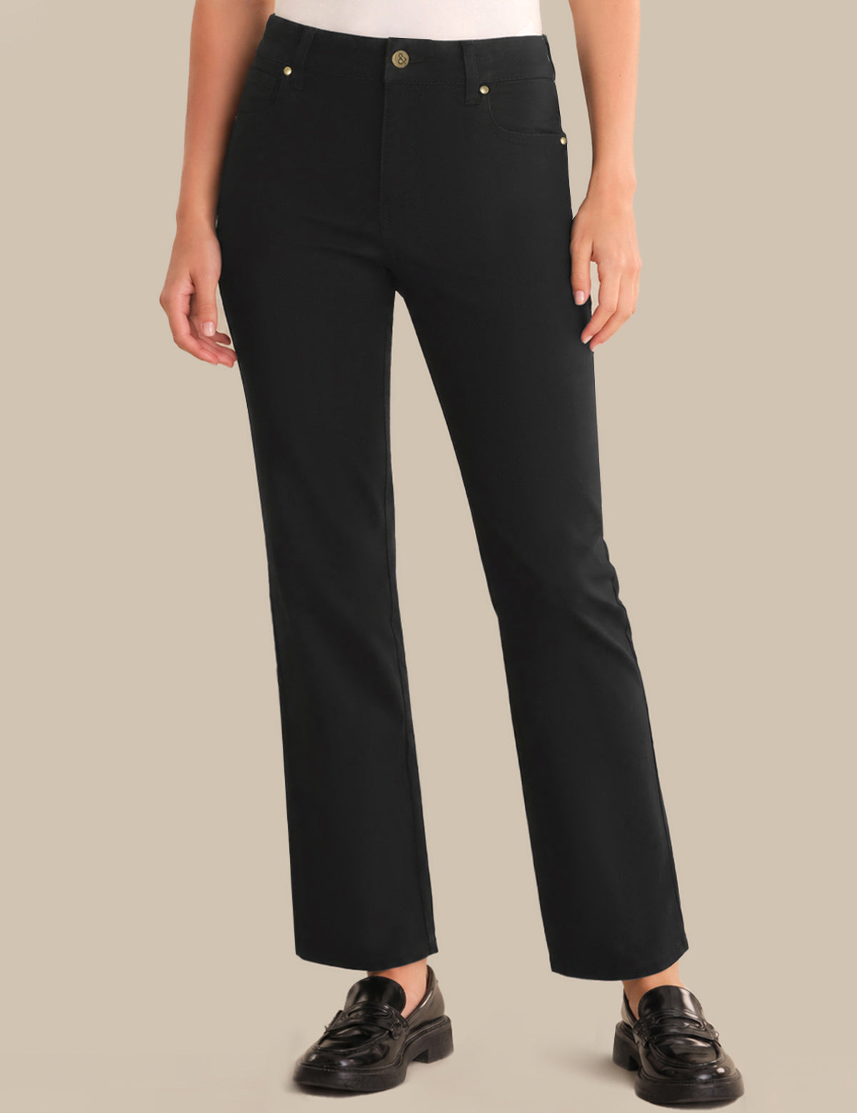 Person wearing black pants on a beige background