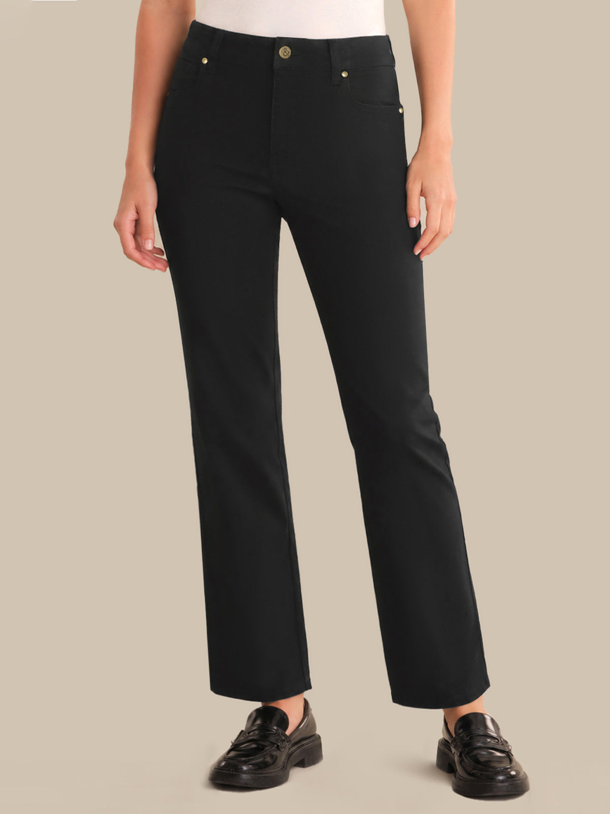 Person wearing black pants on a beige background