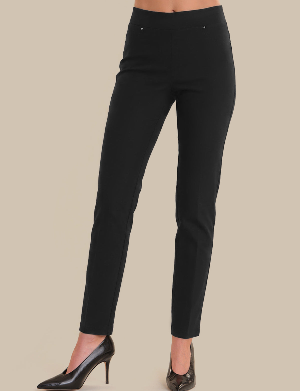 Black pants worn by a person on a beige background