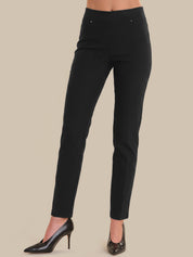 Black pants worn by a person on a beige background