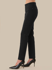 Black pants worn by a person on a beige background