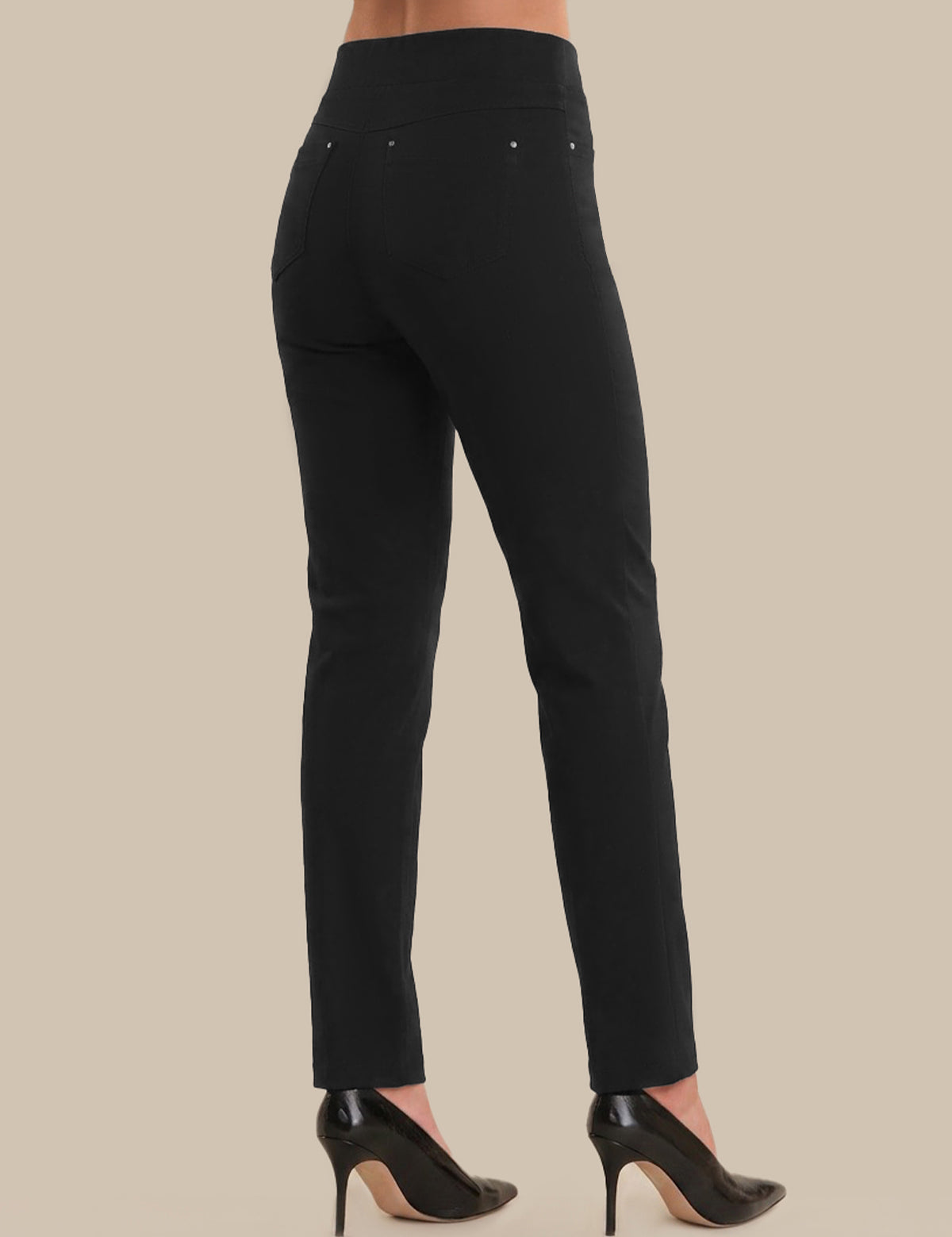 Black pants worn by a person on a beige background