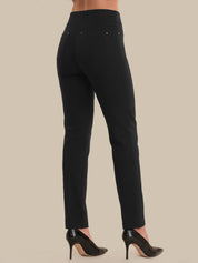 Black pants worn by a person on a beige background
