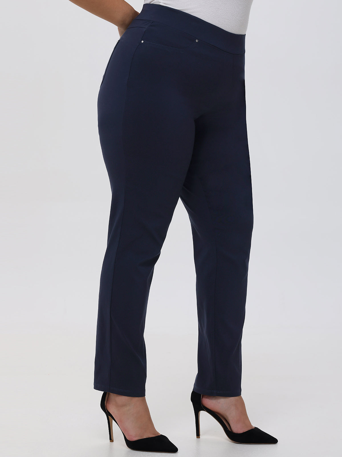 Navy blue pants worn by a person on a white background