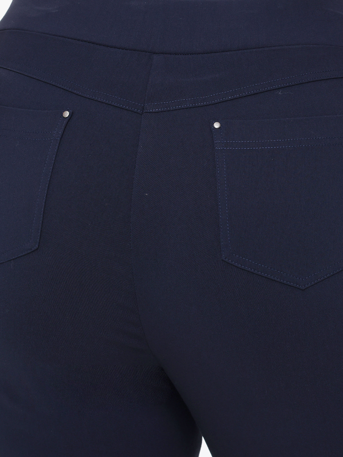 Close-up of dark blue pants with two front pockets.