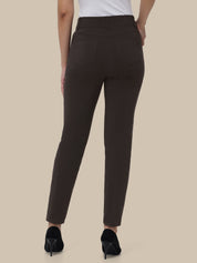 Brown pants worn by a person on a beige background