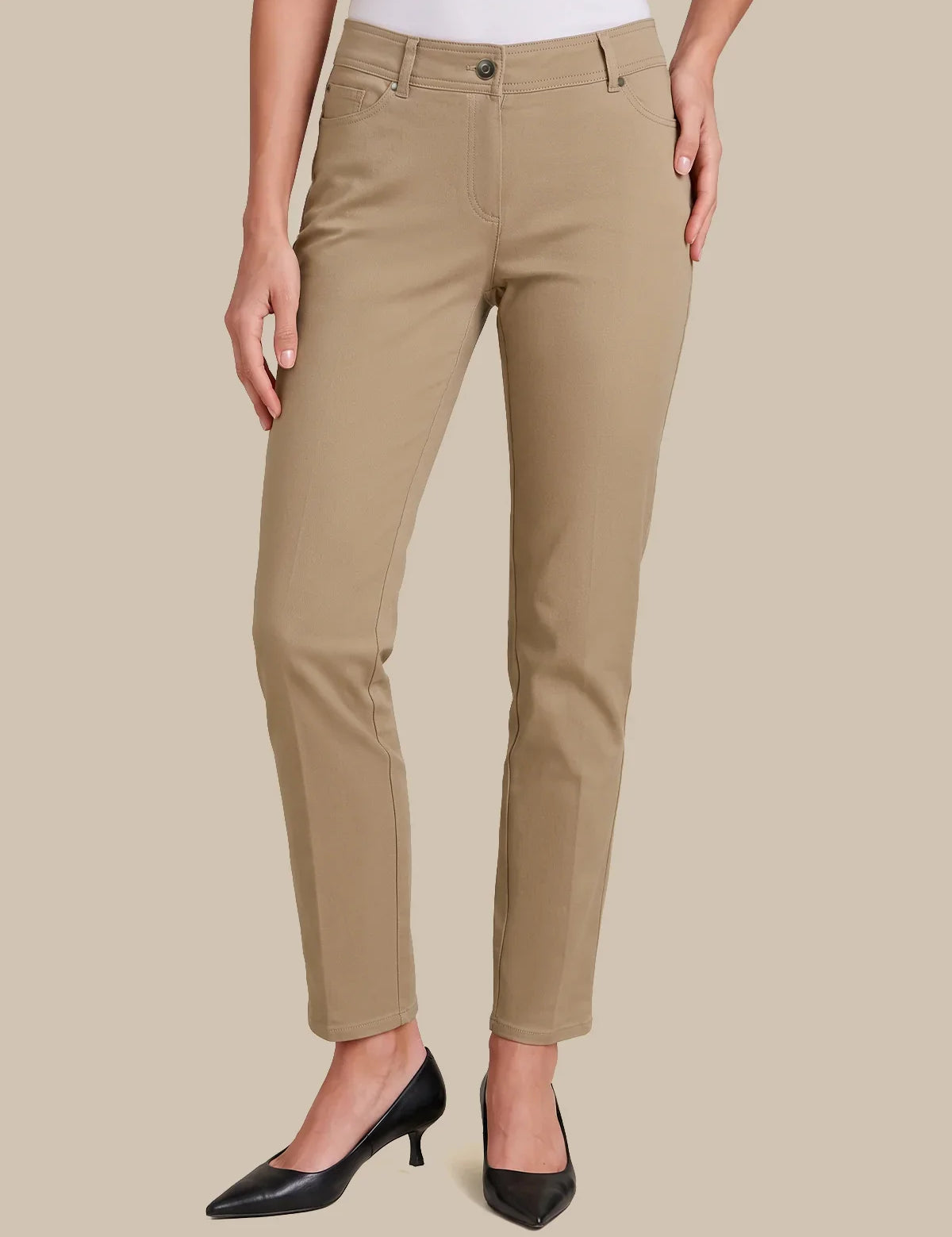 khaki color, styled with black pointed-toe heels against a solid beige background.