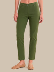 A model wearing olive green cropped pants and tan loafers, shown from the waist down against a solid beige background.
