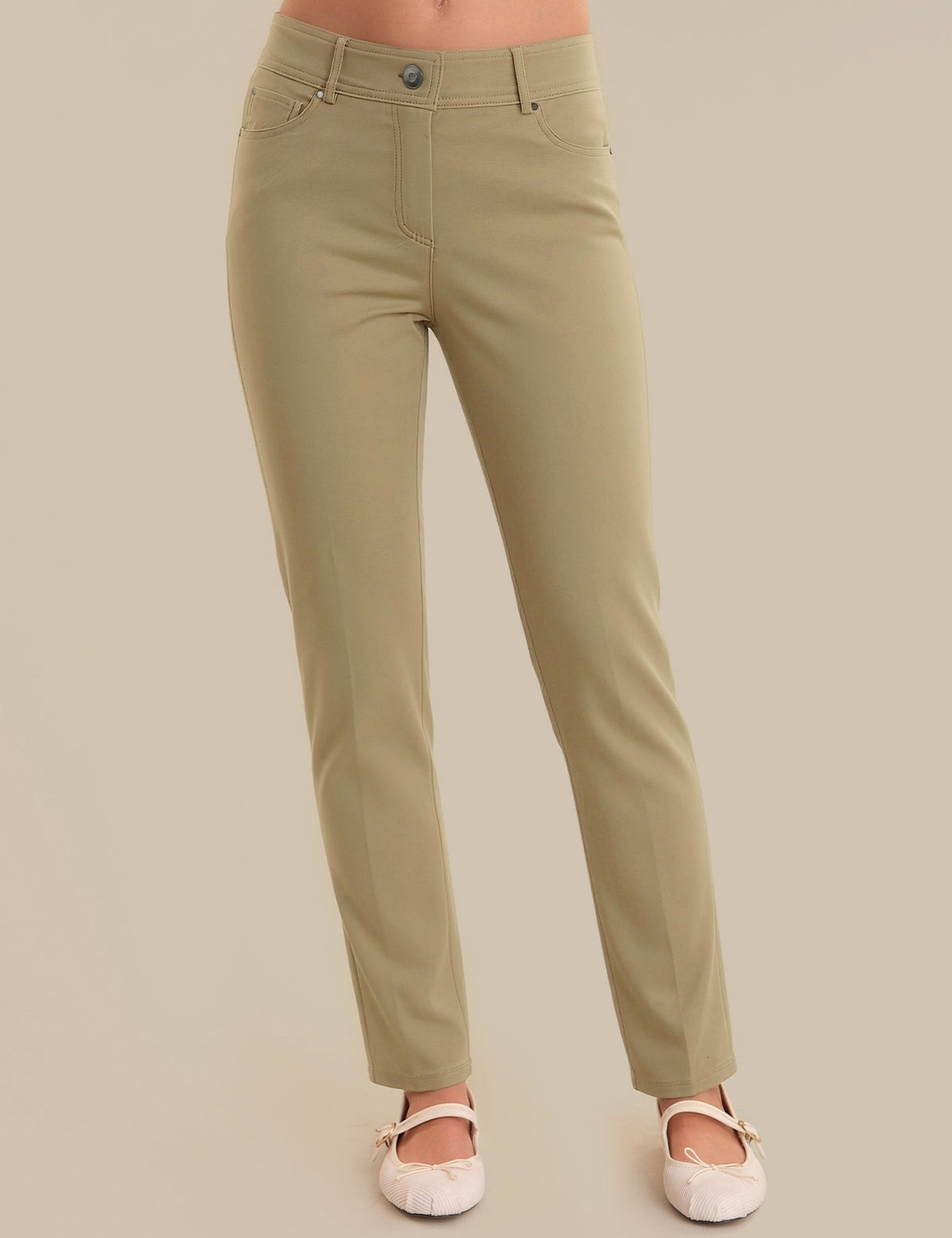 Khaki pants worn by a person on a beige background
