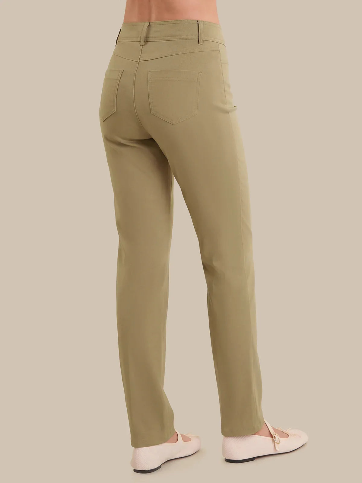 Khaki pants worn by a person on a beige background