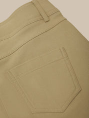 Close-up of beige pants with a pocket on a beige background