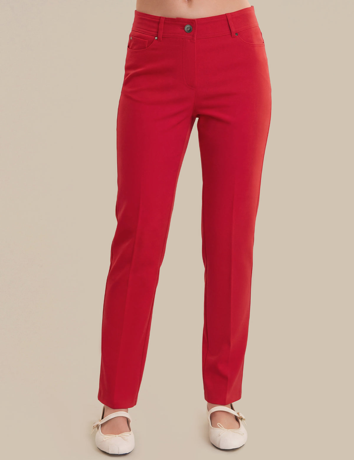 Red pants worn by a person on a beige background
