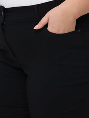 Close-up of a hand in a black pocket of dark pants.