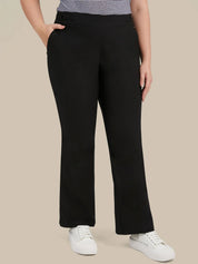 A model wearing black wide-leg cropped pants with a striped top and white sneakers, shown from the waist down against a solid beige background.