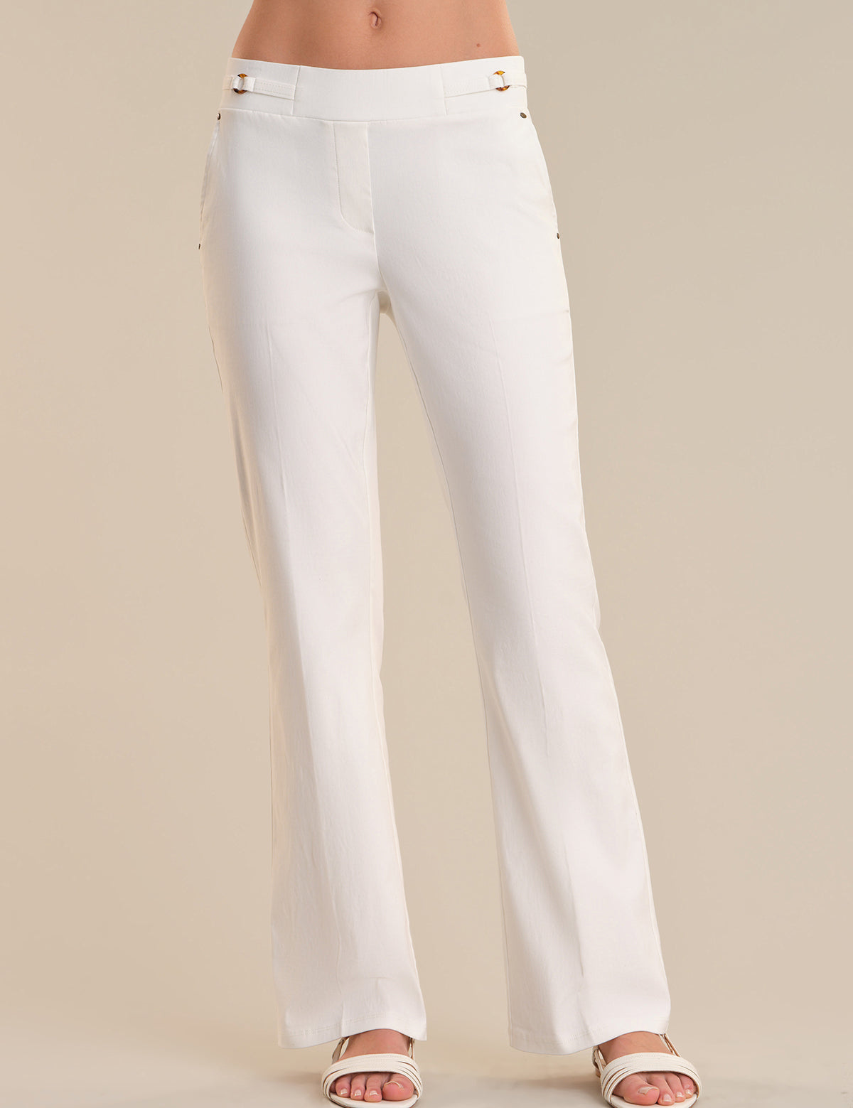 White pants worn by a person on a beige background