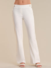 White pants worn by a person on a beige background