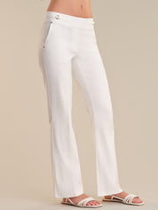 White pants worn by a person on a beige background