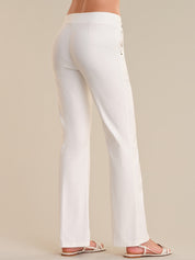 White pants worn by a person on a beige background
