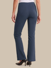 A model shown from the back wearing a pair of slate blue flare pants with black high heels, set against a solid beige background.