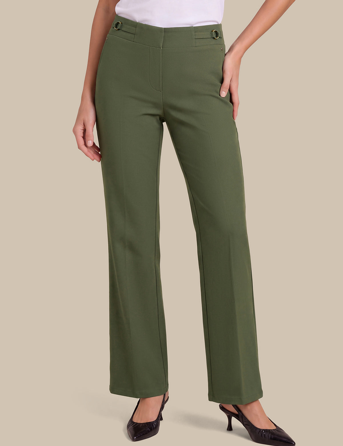 A model wearing olive green wide-leg trousers with a white top and black heels, shown from the waist down against a solid beige background.