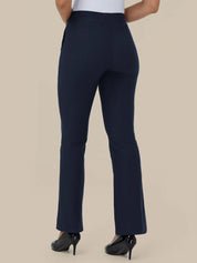 A person shown from the back wearing high-waisted navy blue flared pants with black high heels against a plain beige studio background.