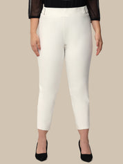 White pants worn by a person on a beige background