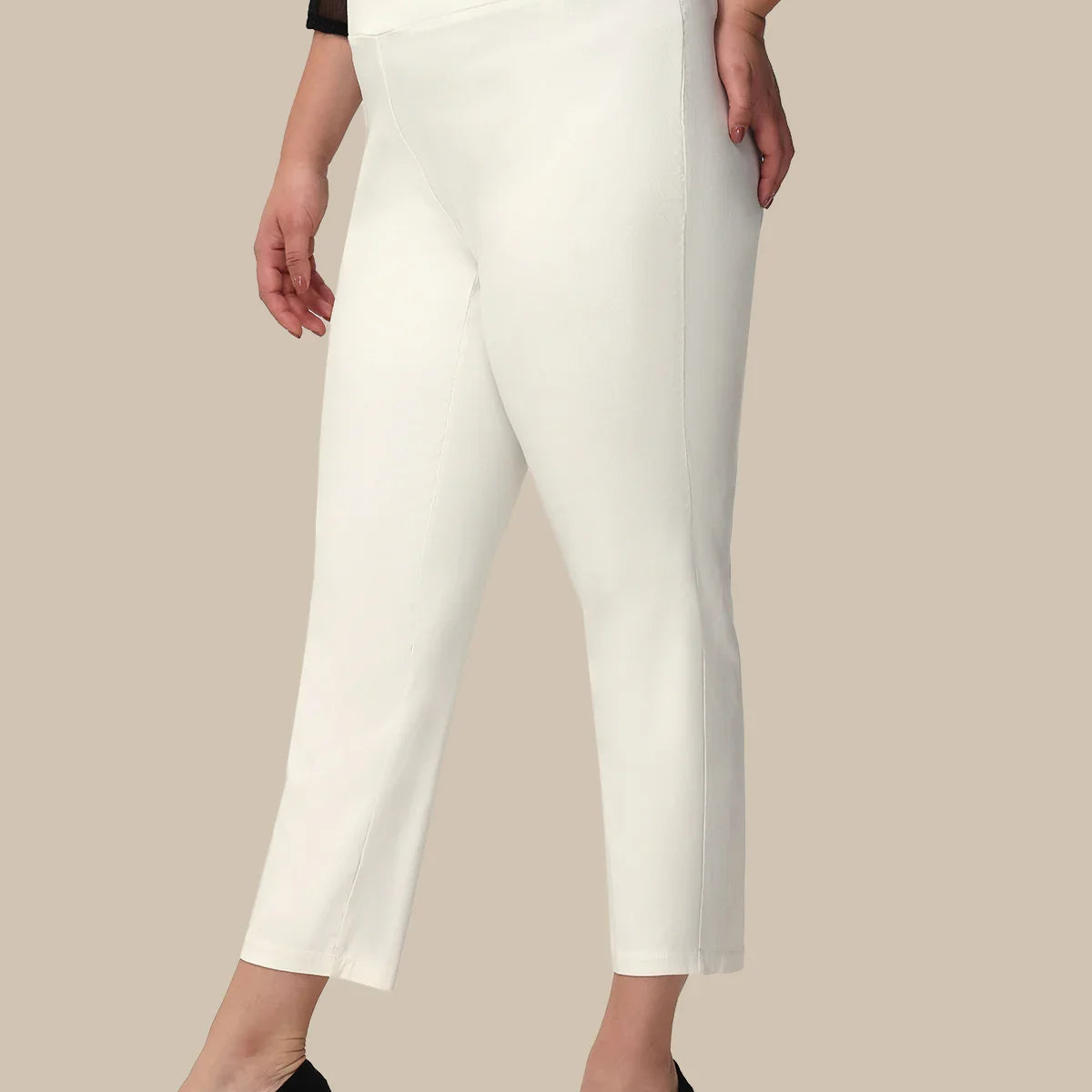 Woman wearing white pants on a beige background