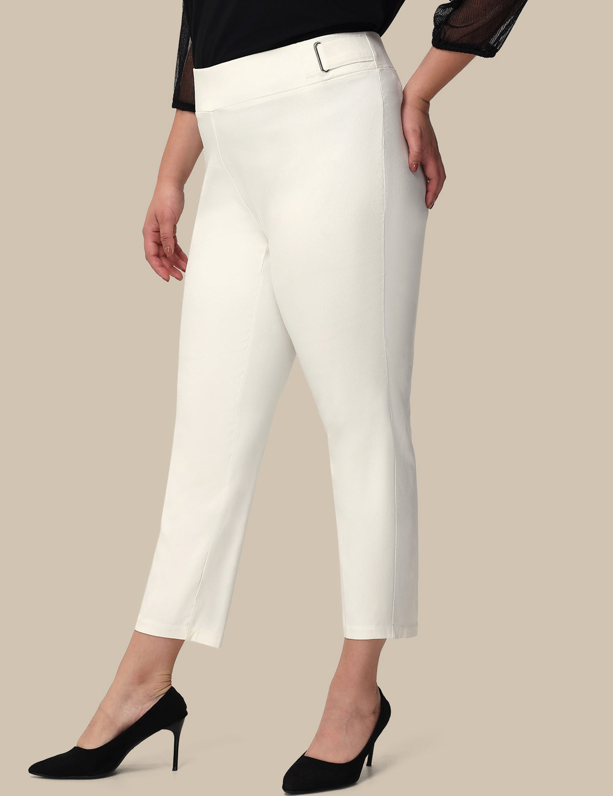 Woman wearing white pants on a beige background