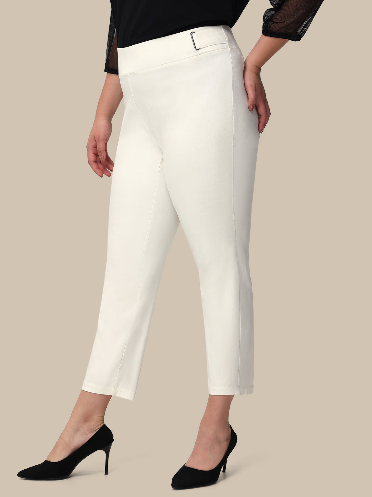 Woman wearing white pants on a beige background