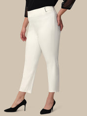 Woman wearing white pants on a beige background