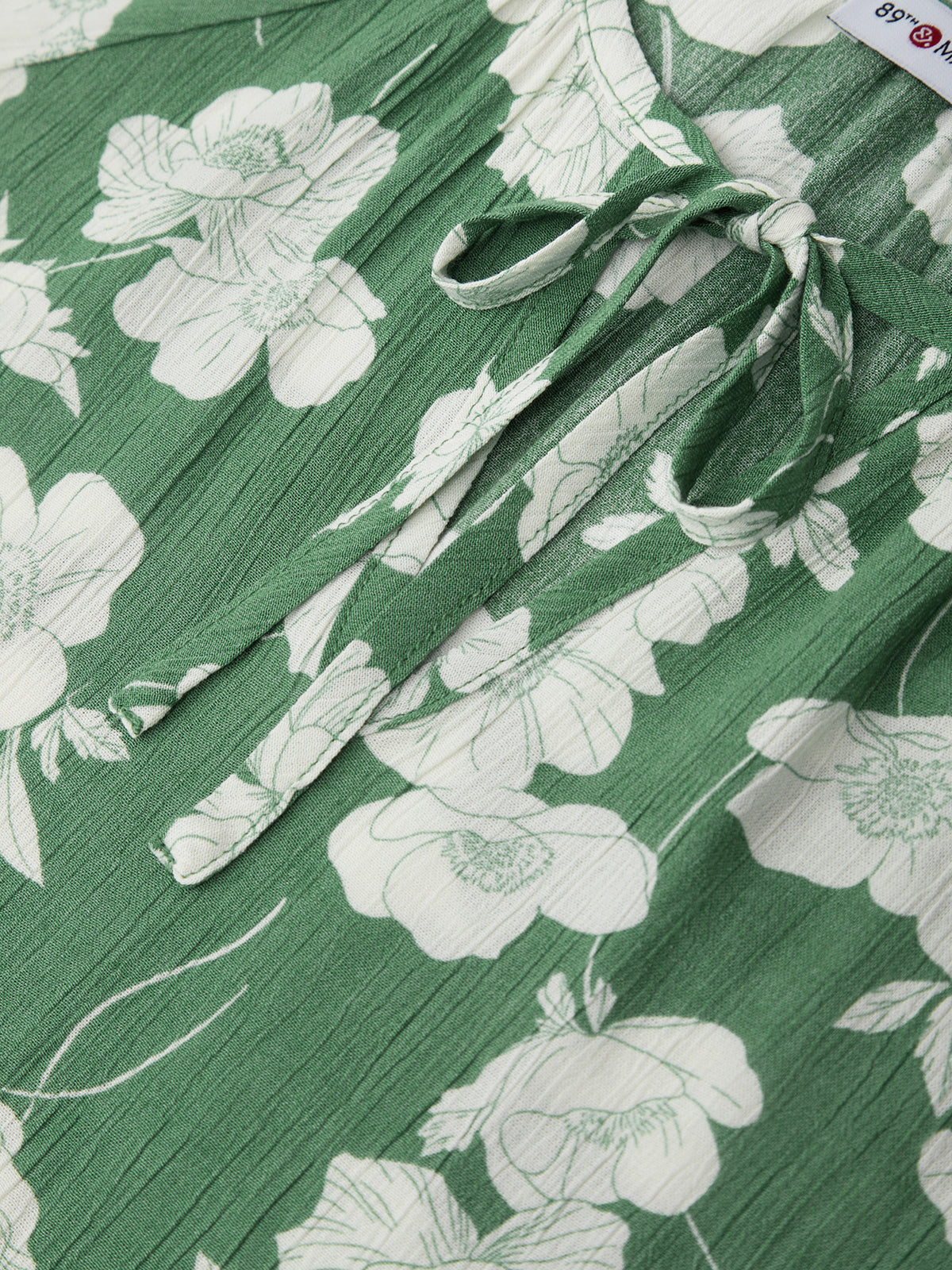 Green fabric with white floral pattern and tied bow