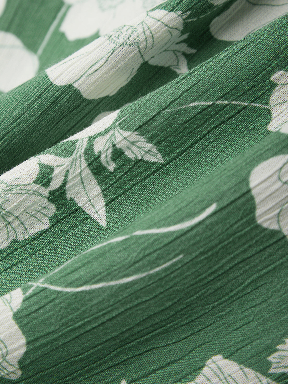 Close-up of green fabric with white floral patterns