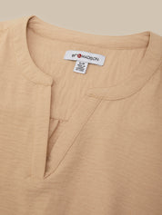 Close-up of a beige linen henley top with a white neck label reading 89 MADISON.