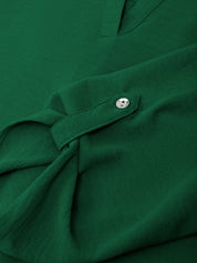 Close-up of a green shirt with a button