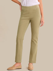 Person wearing olive green pants on a beige background