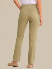 Person wearing olive green pants on a beige background