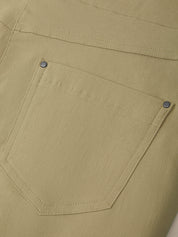 Close-up of a beige pocket on a garment with visible stitching details.