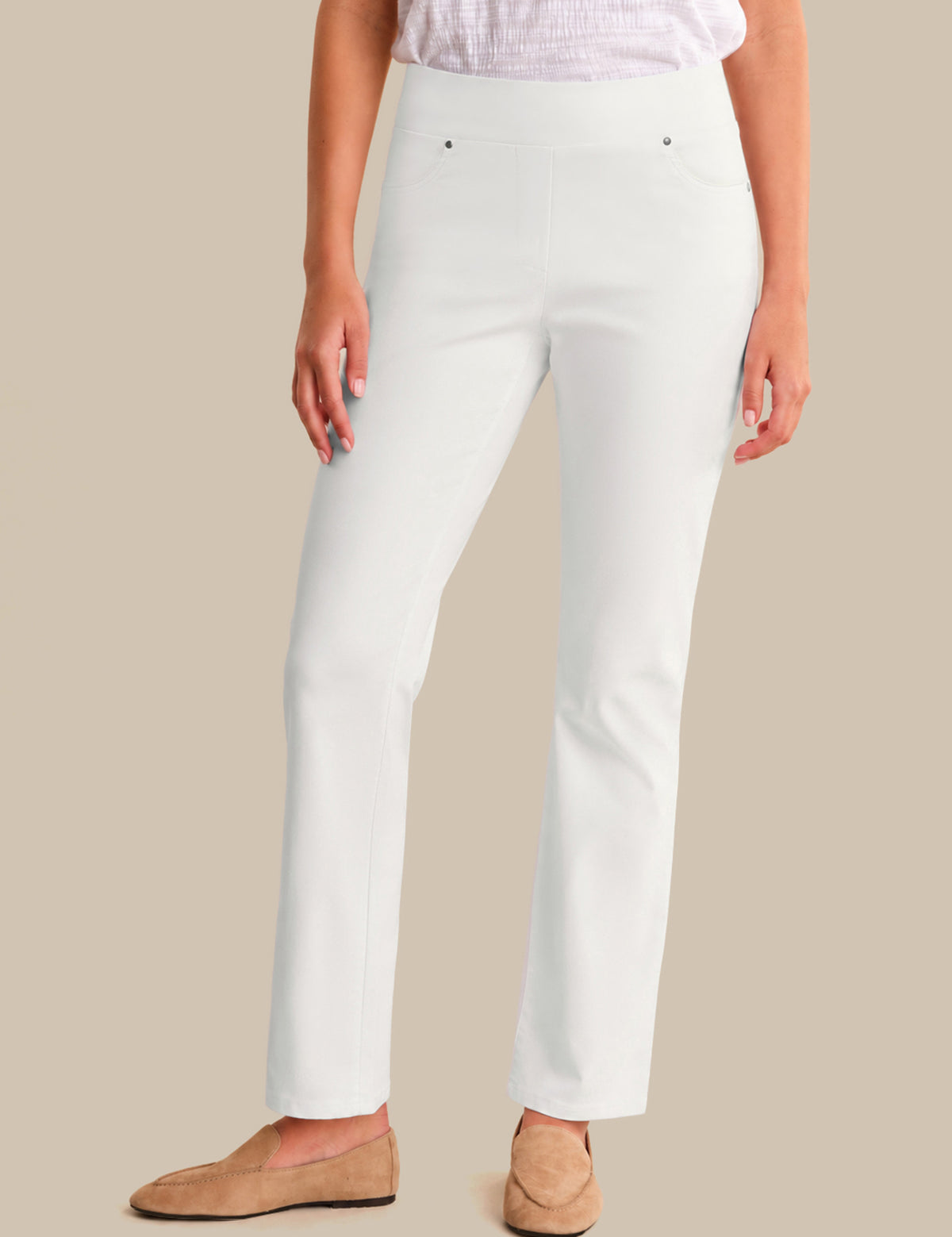 Person wearing white pants on a beige background
